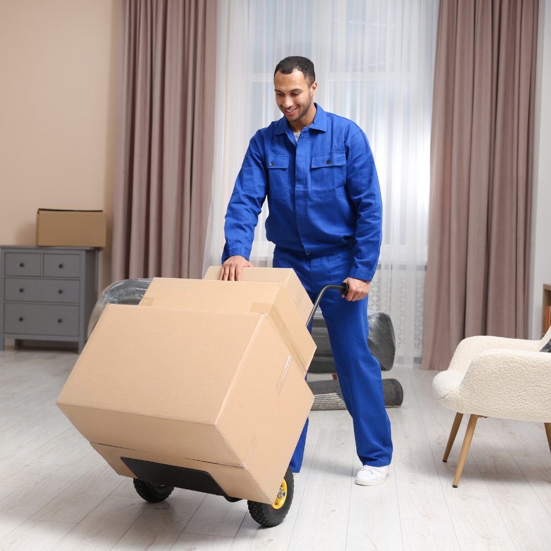 A mover in a blue uniform uses a hand truck to Jewelry Packaging and Protecting inside a home.